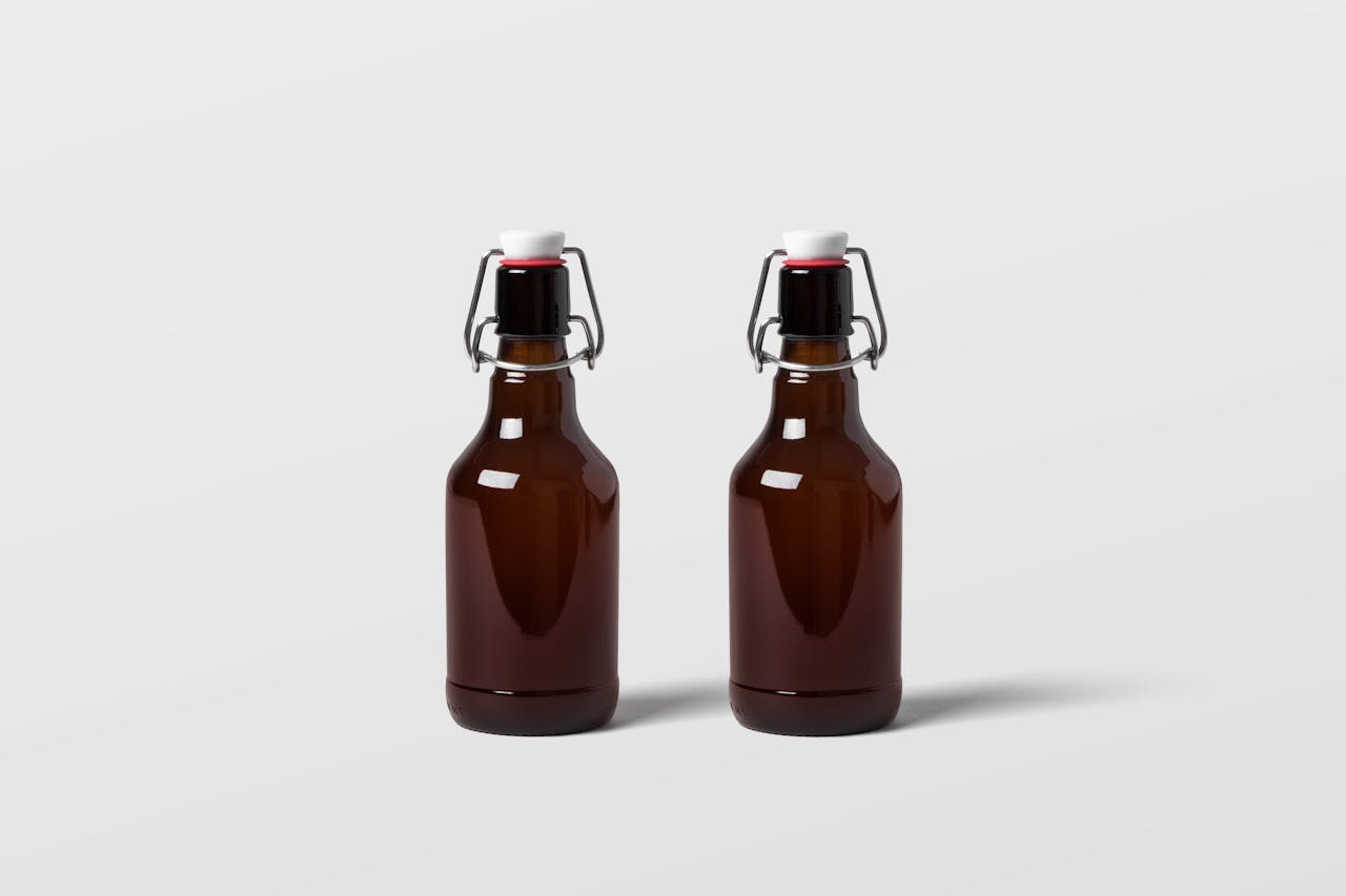 our-services-3 Two brown glass bottles with swing tops on a plain backdrop. Perfect for mockups and product displays.
